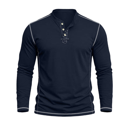 A men's long-sleeve henley shirt in dark navy blue, featuring light gray contrast stitching along the shoulders, sides, and cuffs, and a three-button placket with a small embroidered shield logo on the chest.